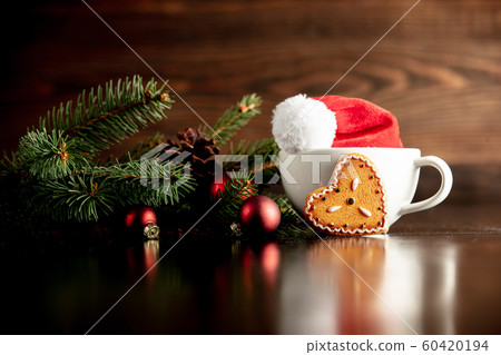 Santa Claus hat and cup with gingerbread cookie Santa Claus hat and cup with gingerbread cookie 60420194