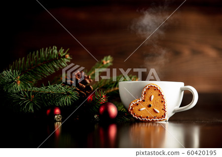 Cup of coffee and gingerbread cookie on a table Cup of coffee and gingerbread cookie on a table 60420195