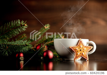 Cup of coffee and gingerbread cookie on a table 60420196
