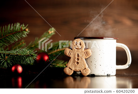 Cup of coffee and gingerbread man cookie 60420200