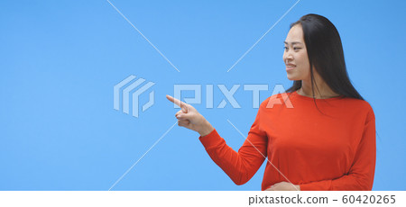 Young woman pointing with finger 60420265