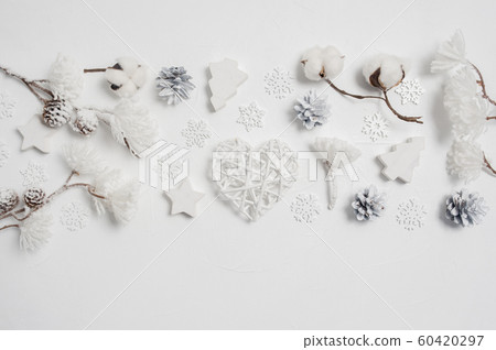 Design elements Christmas greeting card with Xmas gift box, cones, cotton flowers, heart, snowflakes with place for your text. Decorations on a white wooden background Design elements Christmas greeting card with Xmas gift box, cones, cotton flowers, heart, snowflakes with place for your text. Decorations on a white wooden background 60420297