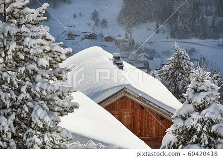 Winter mountain village, roof and chimney covered with snow 60420418