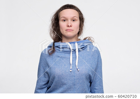 Emotionless, unsentimental phlegmatic caucasian teenager with serious look looking at camera. 60420710