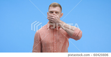 Young man silencing himself Young man silencing himself 60420806