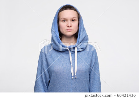 Emotionless, unsentimental phlegmatic caucasian teenager with serious look looking at camera. Emotionless, unsentimental phlegmatic caucasian teenager with serious look looking at camera. 60421430
