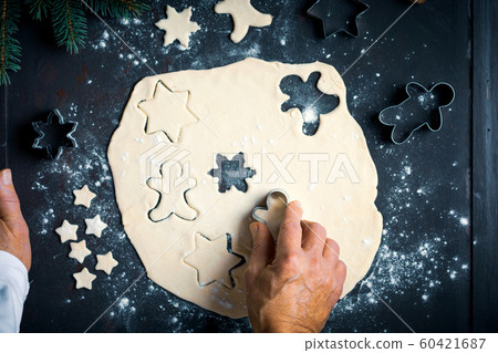 Man making a festive decorated pastry at home Man making a festive decorated pastry at home 60421687