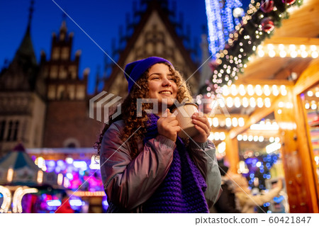 happy young girl in hat with cup on Christmas market happy young girl in hat with cup on Christmas market 60421847