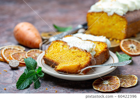 Slices of homemade carrot cake on a ceramic plate. 60422396