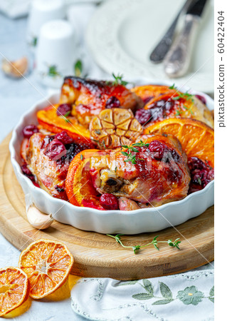 Chicken thighs baked with orange, garlic and 60422404
