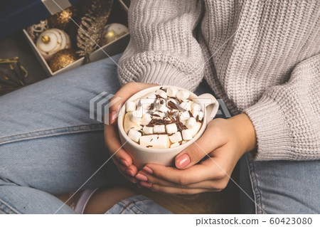 Hot sweet cocoa christmas drink in female hands. Hot sweet cocoa christmas drink in female hands. 60423080