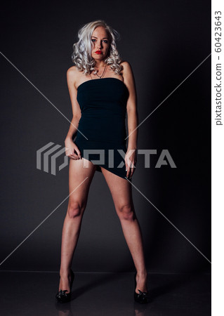 sexy blonde girl in a green dress tight 60423643