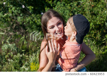Beautiful mom with her son on a picnic rest in nature 60423953