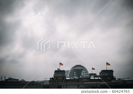 building of the German Bundestag from outside with dark, cloudy sky 60424765