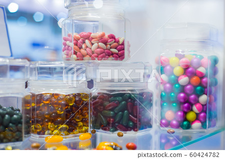 Supplements and pills in clear glass bottle for sale at pharmacy drug store Supplements and pills in clear glass bottle for sale at pharmacy drug store 60424782