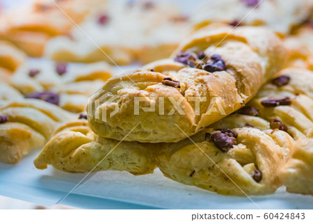 Assortment of freshly baked sweet pastry for sale on counter of french bakery 60424843