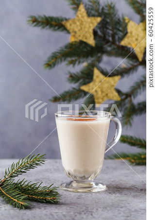 Christmas background with, gift boxes, stars, festive decor, fir tree, cinnamon sticks, hot eggnog Christmas background with, gift boxes, stars, festive decor, fir tree, cinnamon sticks, hot eggnog 60425559