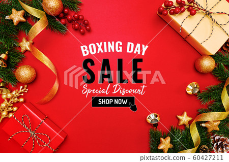 Boxing day sale with Christmas present and xmas decoration on red background 60427211