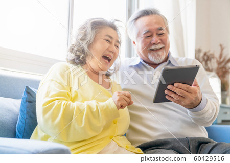 Elderly couple lifestyle personal computer 60429516