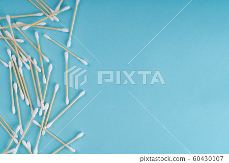 Cotton wooden ear swabs on blue background. Top view. Eco friendly, no plastic 60430107