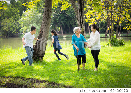 Happy family,asian little child girl or daughter playing touch,tag game,fun,running with father,senior grandmother and mother having smile,laugh in outdoor park,parents enjoy,happy vacation concept Happy family,asian little child girl or daughter playing touch,tag game,fun,running with father,senior grandmother and mother having smile,laugh in outdoor park,parents enjoy,happy vacation concept 60430470