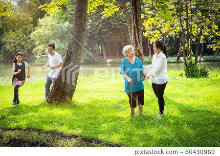 Happy family,asian little child girl or daughter playing touch,tag game,fun,running with father,senior grandmother and mother having smile,laugh in outdoor park,parents enjoy,summer vacation concept Happy family,asian little child girl or daughter playing touch,tag game,fun,running with father,senior grandmother and mother having smile,laugh in outdoor park,parents enjoy,summer vacation concept 60430980