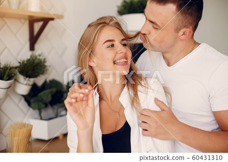 Beautiful couple spend time in a kitchen 60431310