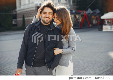 Beautiful couple spend time in a summer city 60431909