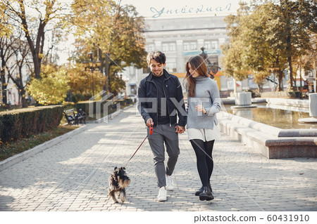 Beautiful couple spend time in a summer city Beautiful couple spend time in a summer city 60431910