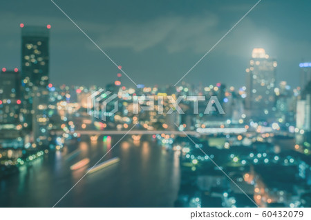 Blur city background rooftop view of Bangkok cityscape business building landscape night lights bokeh in vintage blue tone Blur city background rooftop view of Bangkok cityscape business building landscape night lights bokeh in vintage blue tone 60432079