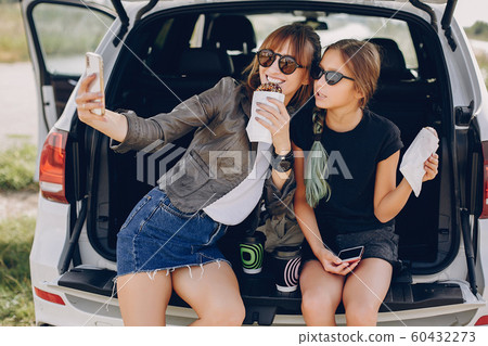 Cute and stylish family in a summer field Cute and stylish family in a summer field 60432273