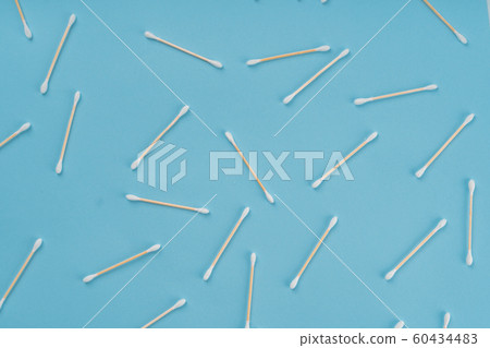 Pattern of cotoon wooden swabs on blue background. Eco friendly concept of zero waste Pattern of cotoon wooden swabs on blue background. Eco friendly concept of zero waste 60434483
