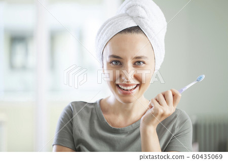Portrait of a smiling cute woman holding 60435069