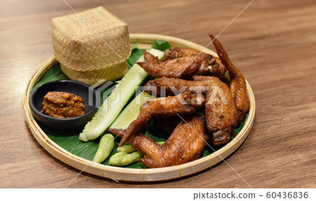 Fried chicken wing set with sticky rice and chili Fried chicken wing set with sticky rice and chili 60436836