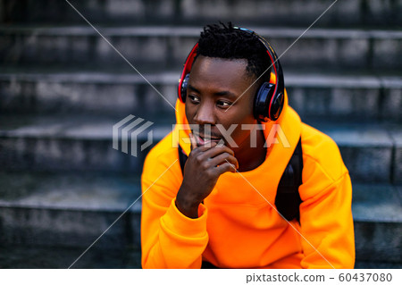 african-american man in wireless headphones listening music 60437080