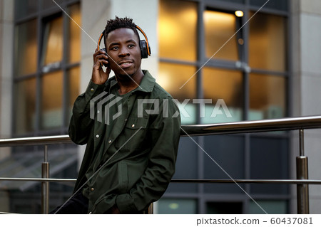african-american man in wireless headphones listening music african-american man in wireless headphones listening music 60437081