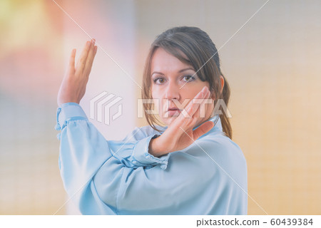 Woman doing qi gong tai chi exercise 60439384