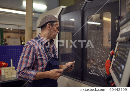 Engineer controlling the work of machine online Engineer controlling the work of machine online 60442509