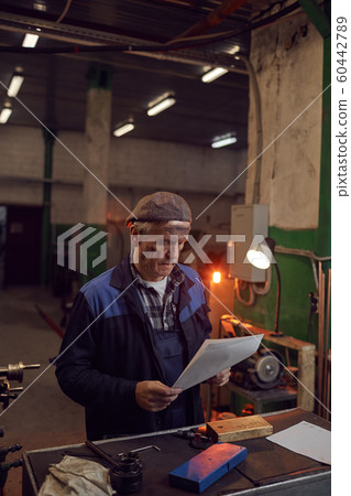 Worker reading the document Worker reading the document 60442789