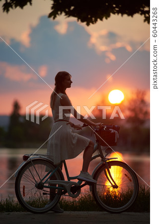 Pretty girl with a blue bike 60443268