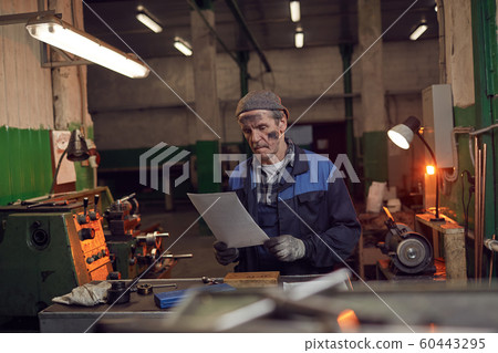Worker examining the contract 60443295