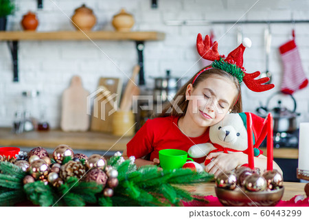 Good morning. A cute sleepy girl drinks tea at the 60443299