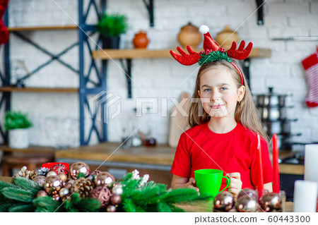 Good morning. A cute sleepy girl drinks tea at the Good morning. A cute sleepy girl drinks tea at the 60443300