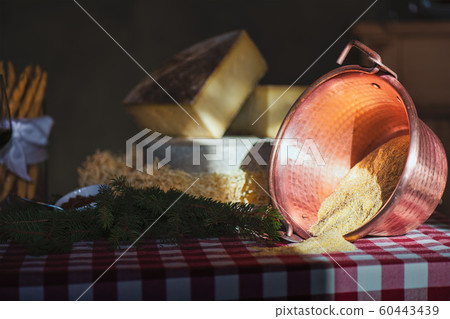 Polenta pot on the table with cheese Polenta pot on the table with cheese 60443439