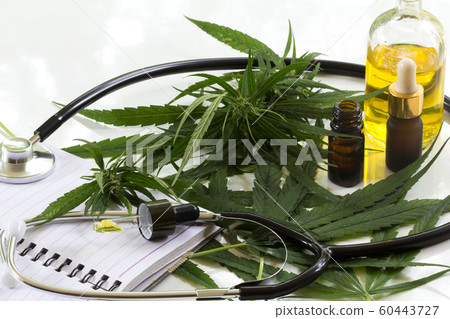 Hemp oil bottles and green cannabis leaves 60443727