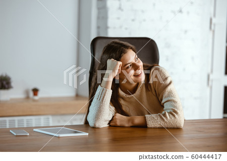 Portrait of young caucasian girl in casual clothes looks dreamful and happy 60444417