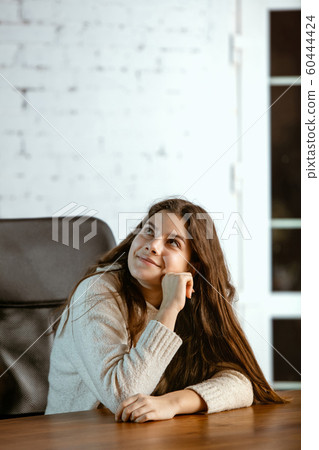 Portrait of young caucasian girl in casual clothes looks dreamful and happy 60444424