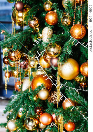 Decorated Christmas tree in gold and yellow Decorated Christmas tree in gold and yellow 60444603