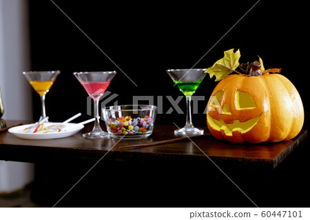 Ghost pumpkins, candies, and drinks on the table 60447101