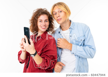 Stylish caucasian couple in love listen to music and do selfie isolated on white background Stylish caucasian couple in love listen to music and do selfie isolated on white background 60447944